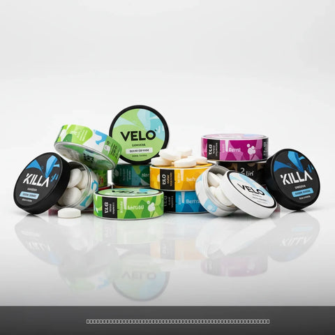 VELO and KILLA branded nicotine pouch containers with various coloured labels and loose white pouches on a white surface