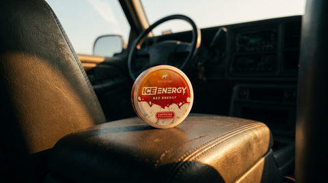 ICE Energy Extra Strong caffeine pouch can resting on a car centre console with blurred dashboard behind