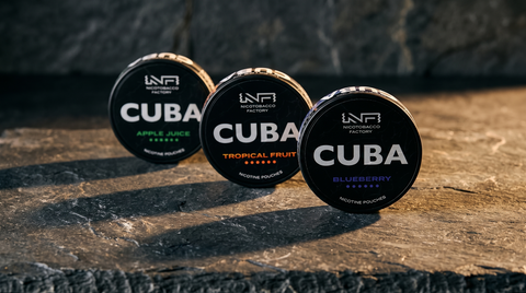 Three CUBA Black 150mg nicotine pouch cans arranged on a dark slate worktop