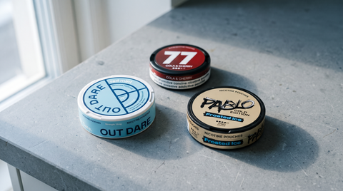 Three nicotine pouch cans from the cuba blackline buying guide on a grey stone worktop