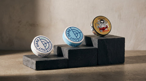 OutDare 6 mg, OutDare 12 mg and PABLO nicotine pouch cans rising on stone steps by strength