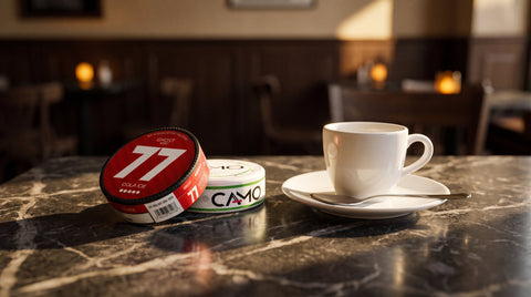 Nicotine pouches and an espresso cup on a dark Viennese marble café table