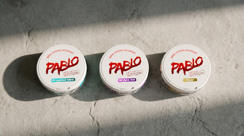 Three PABLO nicotine pouch cans standing in a row on a pale grey stone worktop