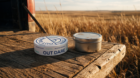 OutDare Rad Mint nicotine pouch can beside a plain round can on a weathered wooden truck tailgate outdoors