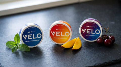 VELO Crispy Peppermint, Tropical Mango and Icy Cherry cans with mint, mango and cherries