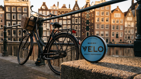 A nicotine pouch can resting beside a Dutch bicycle at an Amsterdam canal