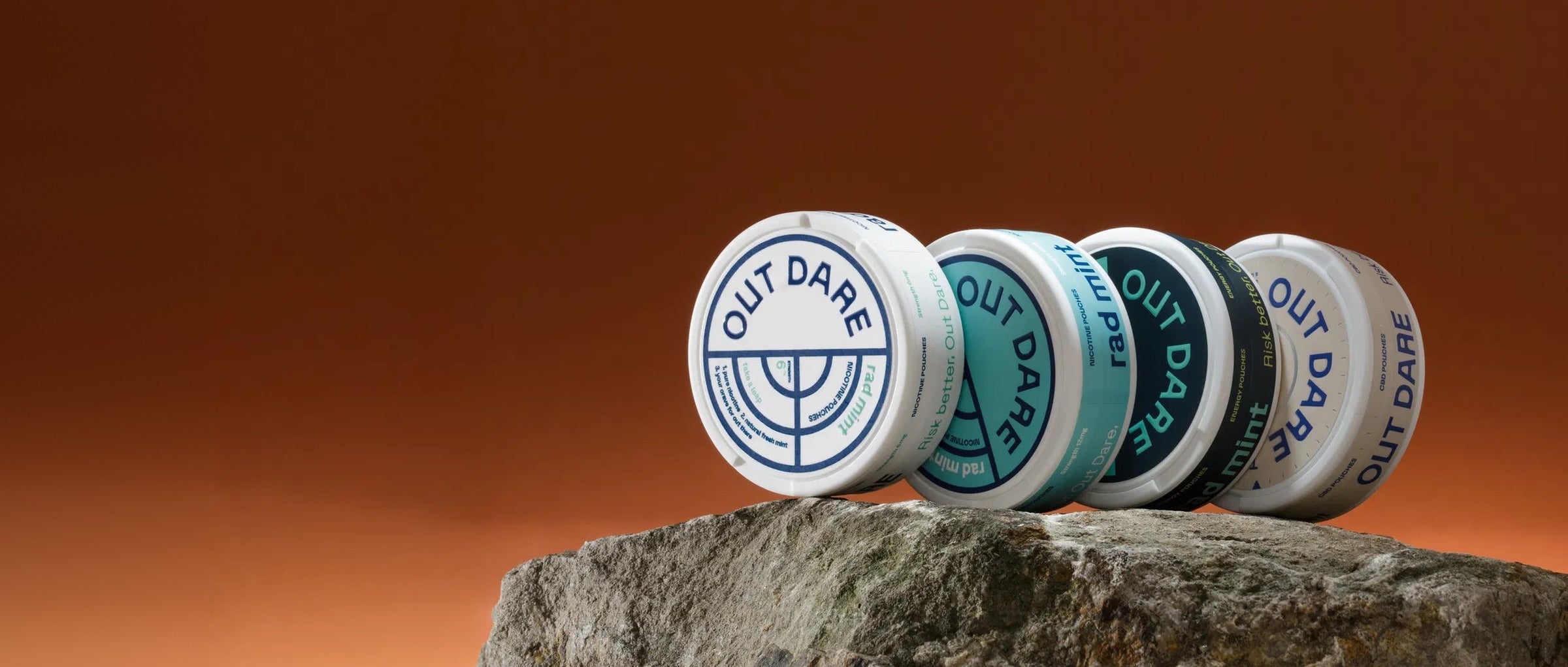 OutDare pouch cans on a rock, wide banner